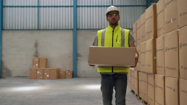 Workers lifting boxes in the warehouse, concept of distribution
