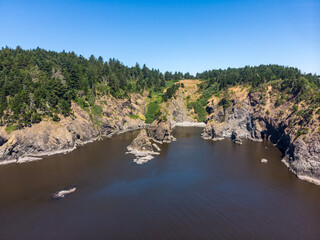 Aerial panorama of Nellies Cove at Port Orford, Oregon. An inlet of Port Orford lifeboat station
