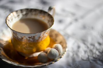 A close up of a yellow and gold coffee/tea cup 