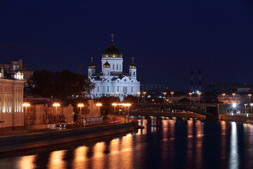 View of a Moscow at night. Cathedral of Christ the Saviour from Bolshoy Moskvoretskiy most, surface of Moskva river covered with colorful reflecting lights