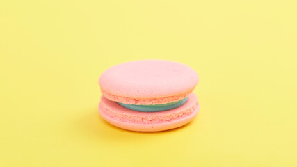 Pink macaroons on bright yellow background