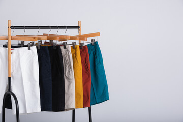Male shorts on clothesline with white background.