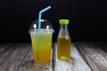 Mock up of herbal juice on the wooden mat. Famous healthy beverage in Asia restaurant. 