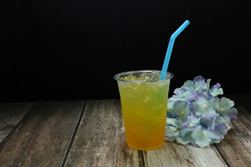 Mock up of herbal juice on the wooden mat. Famous healthy beverage in Asia restaurant. 