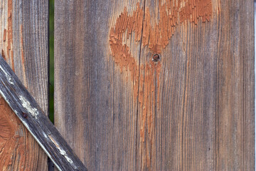 Old wooden barn door with shabby paint close up. Grey weathered rural background.
