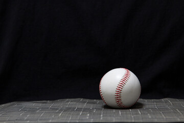 A baseball with a black background