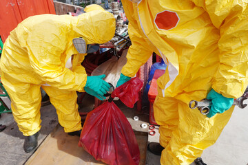 Rescue personnel wear yellow chemical protective clothing during chemical spill recover as part of...