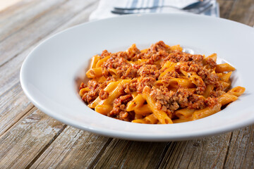 A view of an Italian pasta dish, featuring penne and ground beef.