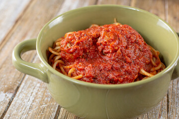 A closeup view of a bowl of spaghetti and marinara sauce.