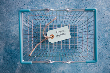 product tags with small business text with customer shopping basket, supporting small local businesses