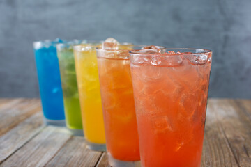 A view of several iced cold drinks with a rainbow motif.