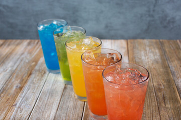 A view of several iced cold drinks with a rainbow motif.