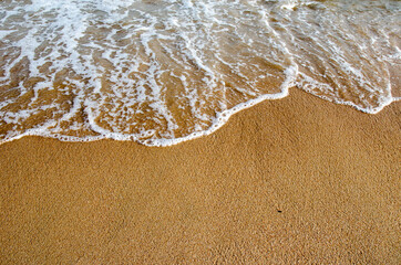 Waves hitting sand shore on a late evening. Photo taken in Asia, Thailand