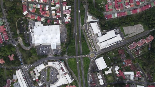 Beautiful cinematic aerial view of a shopping mall in a middle of the city and road