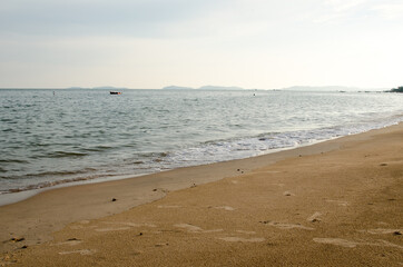 Waves hitting sand shore on a late evening. Photo taken in Asia, Thailand