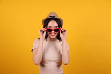 Beautiful young south east Asian woman red frame sunglass hat pose style fashion peak happy on...