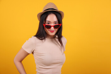 Beautiful young south east Asian woman red frame sunglass hat pose style fashion peak happy on...