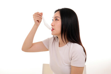 Fototapeta premium Beautiful young south east Asian woman holding chinese empty chopstick soup spoon bowl utensil pretend acting posing see eat taste feed offer satisfaction yummy white background happy