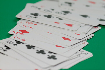 Classic playing cards on green background. Gambling and casino concept.