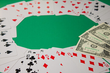 Classic playing cards and dollars on green background. Gambling and casino concept.