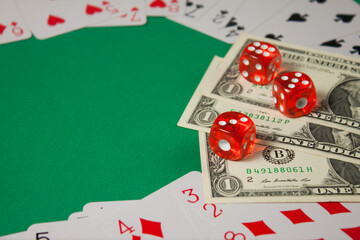 Classic playing cards, red dices and dollars on green background. Gambling and casino concept.