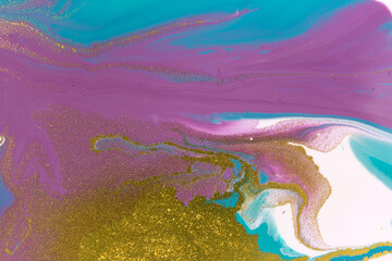 Gold glitter on liquid acrylic background. Marble blue and purple abstract pattern.