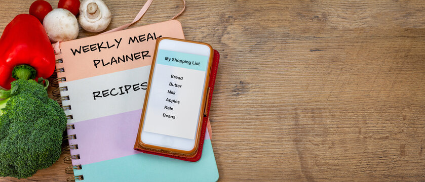 Reduce Food Waste, Grocery Shopping List On Smartphone, With Weekly Meal Planner And Recipe Book On Counter Top, Fresh Vegetables, Plan Meals And Make A Shopping List To Reduce Food Waste.