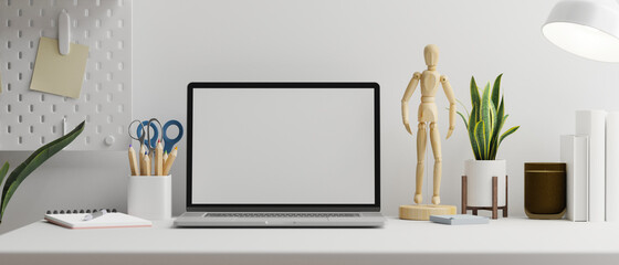 Laptop with mock-up screen on white table with stationery and supplies, 3D rendering