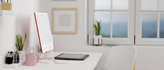 Side view of pink pastel computer monitor with mock-up screen, drawing tablet in office room, 3D rendering