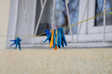 Clothesline on the street. Clothespins for linen.