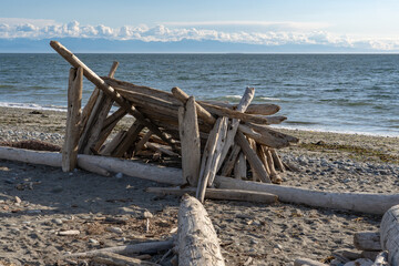 Shelter built from driftwood in Deception Pass State Park, Washington