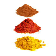 turmeric, paprika, cinnamon powders on white