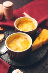 Ramekins with tasty julienne on dark background