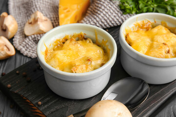 Ramekins with tasty julienne on table, closeup