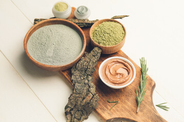 Composition with cosmetic clay on light wooden background