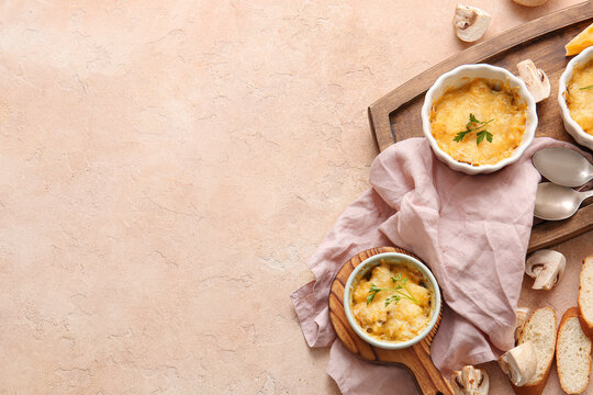 Ramekins with tasty julienne and ingredients on color background