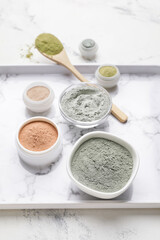 Tray with cosmetic clay on light background