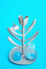 Drying rack for baby bottles on color background