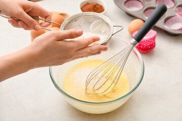 Woman preparing pastry in kitchen