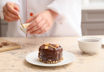 Woman cooking chocolate cake in kitchen