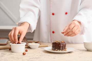 Woman cooking chocolate cake in kitchen