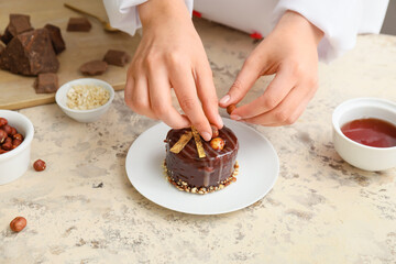 Woman cooking chocolate cake in kitchen