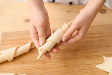 Woman cooking croissants in kitchen, closeup