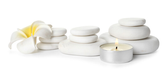 Spa stones, burning candle and flower on white background