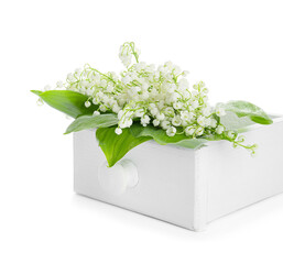Drawer with beautiful lily-of-the-valley flowers on white background