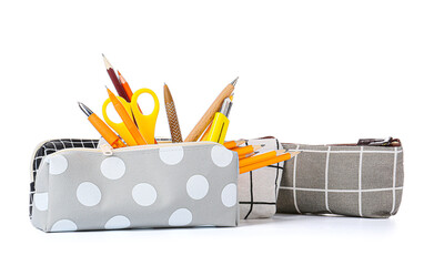 Pencil cases with stationery on white background