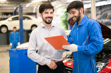 Car service, vehicle repair concept : Car service technician explaining checking list or repaired item to vehicle owner customer after sending car for repairing or check at automobile service center. 