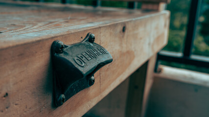 bottle opener on wood bench