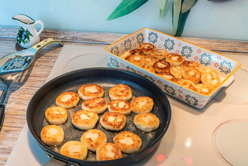 Cheesecakes or Syrniki on a pan. Russian and Ukrainian Cuisine
