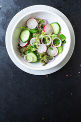 salad vegetable radish, cucumber, green mix leaves veggie meal snack diet vegan or vegetarian food copy space food background rustic top view